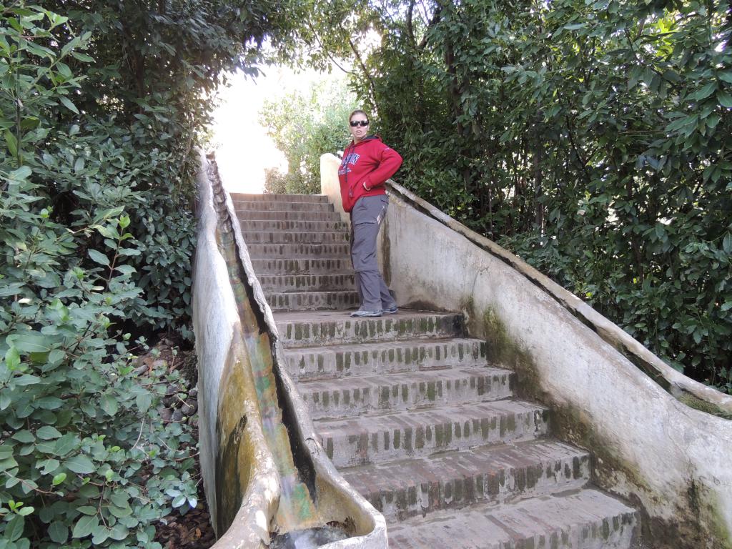 Stairway containing channels for water to run down railing. 