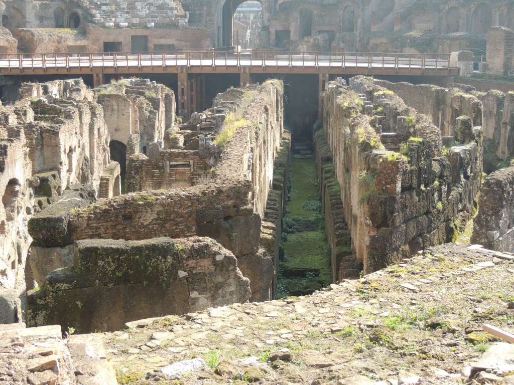 The underground rooms and tunnels where the animals were kept. The wooden floor of the arena has been partially reconstructed in the background.