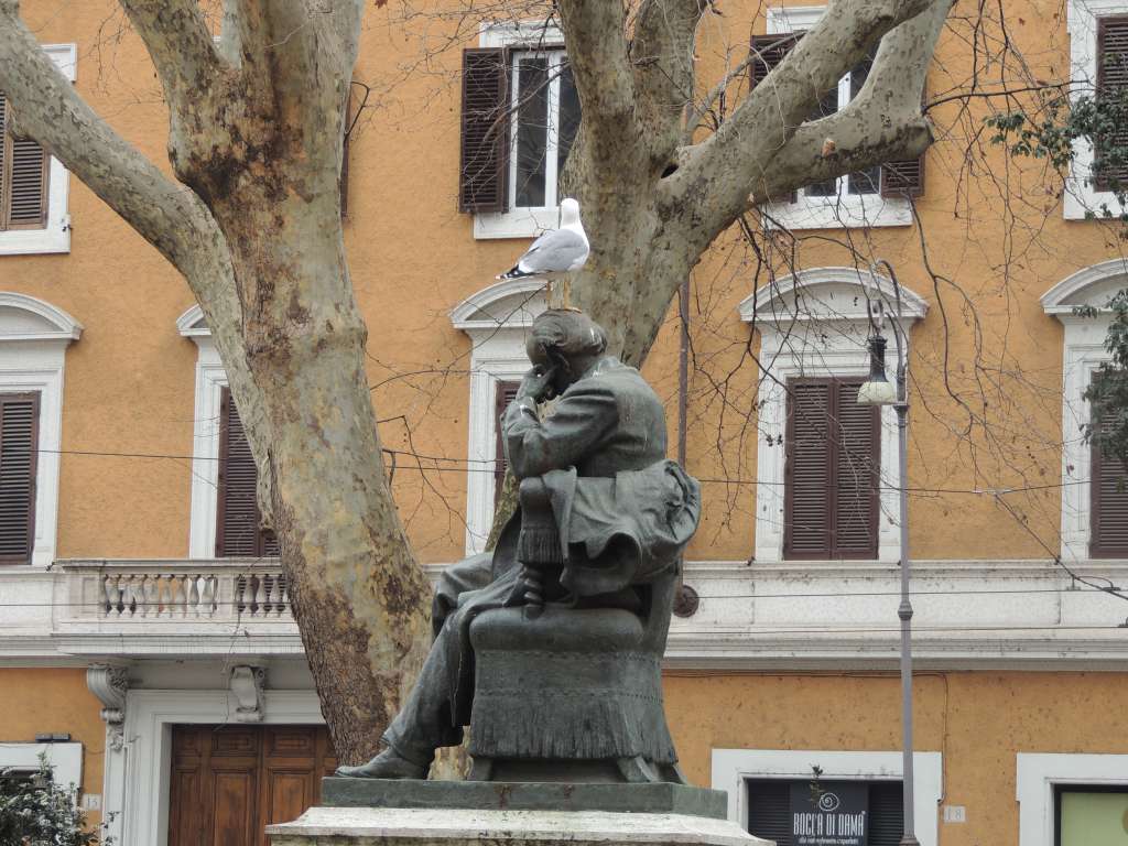 Bird shitting on statues head