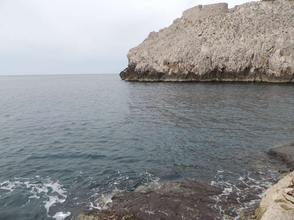 The waters edge down a path we discovered. The water was very inviting but getting out would have involved crawling over very sharp rocks (and no towels etc)