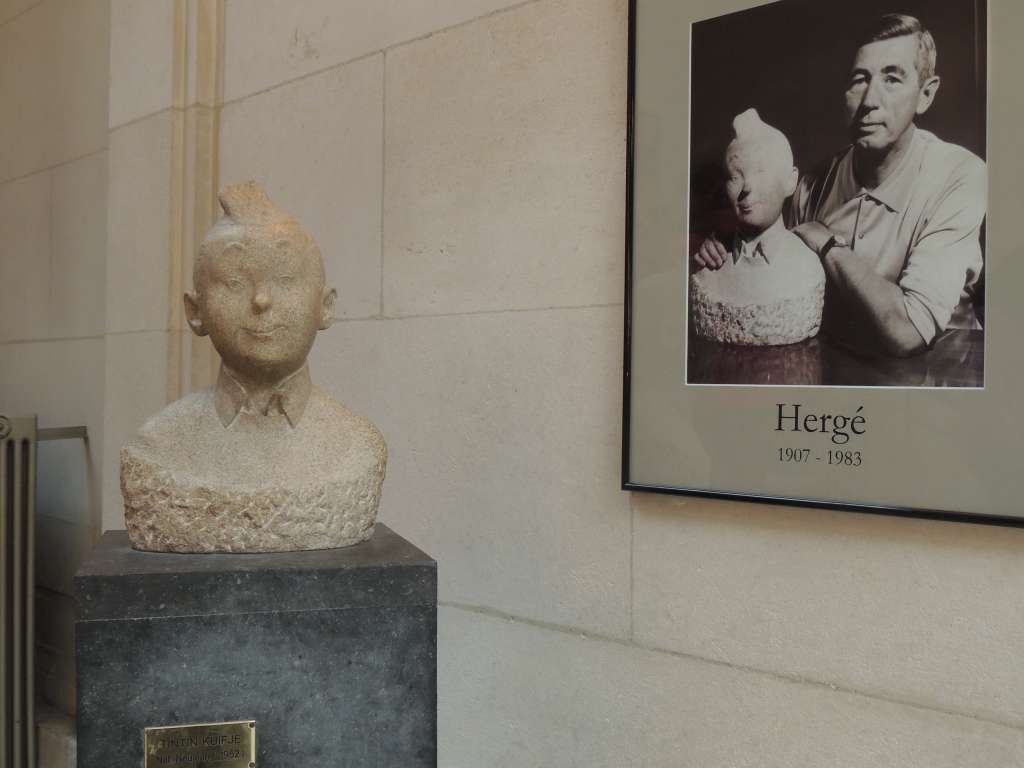 Tintin sculpture with photo of the author Herge