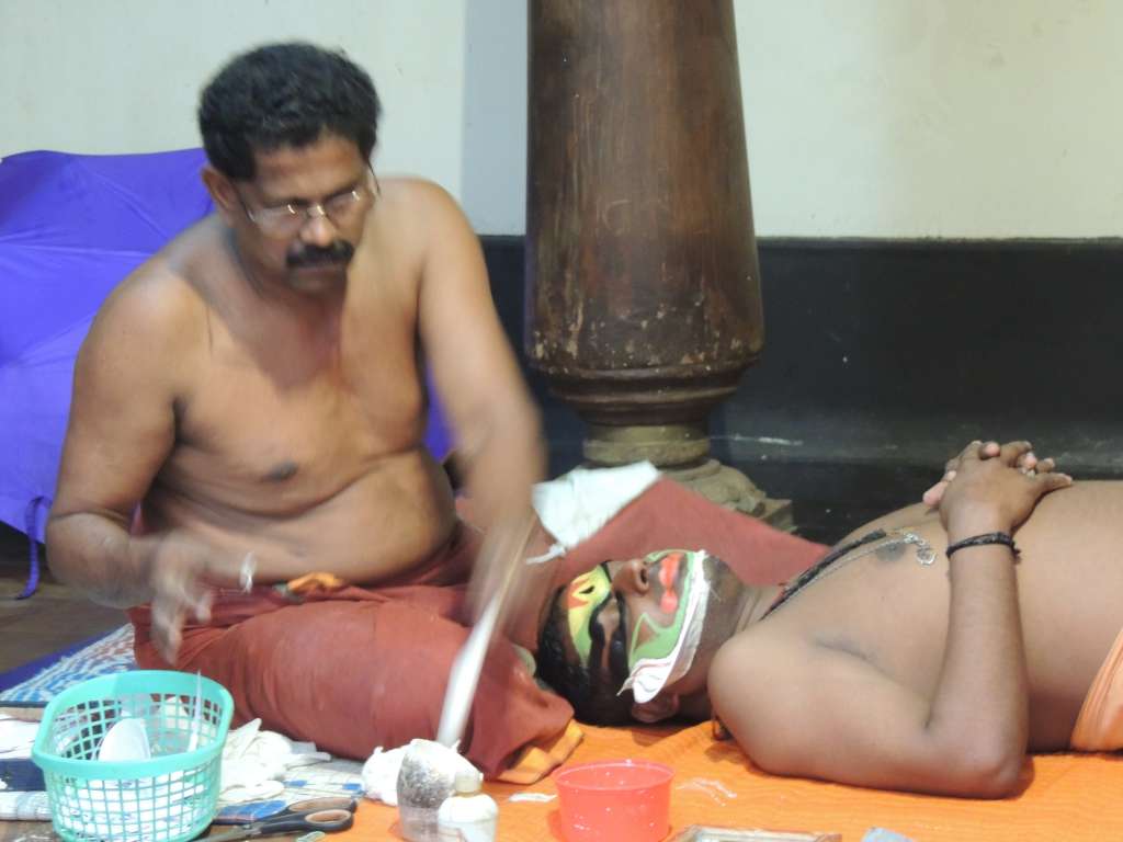 Kathakali performers getting made up