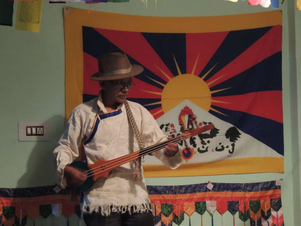 One of the talented Tibetan musicians playing a Tibetan insrument