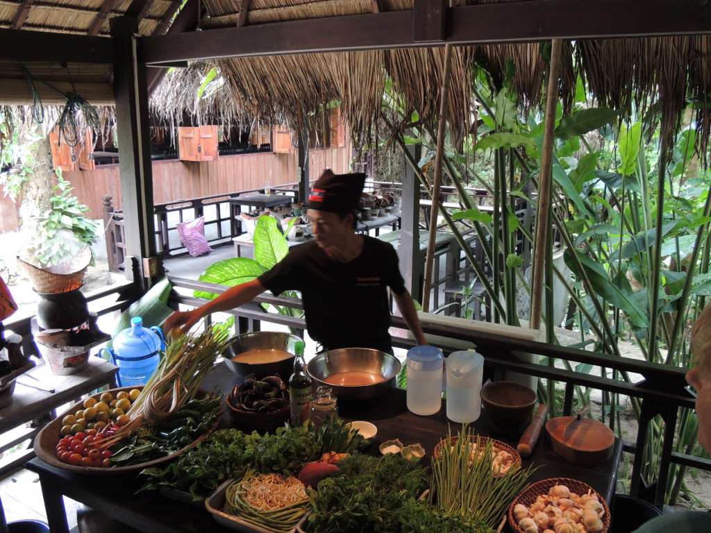 Our host demonstrating the Laos cooking way